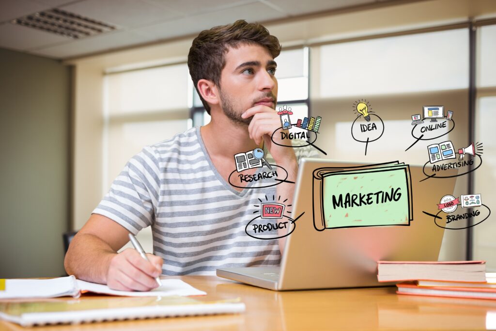 thoughtful-businessman-with-laptop-marketing-graphics-office